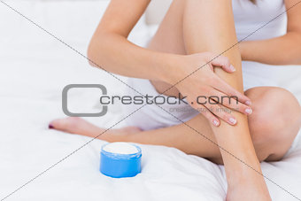 Woman putting some moisturiser