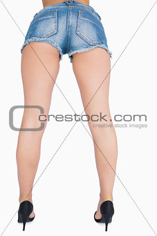 Woman in denim shorts and high heels