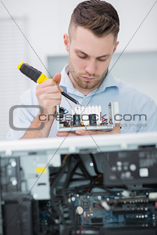 Computer engineer working on cpu part in front of open cpu