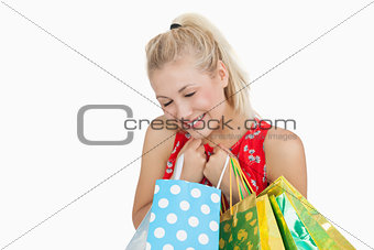 Cute excited young woman with shopping bags