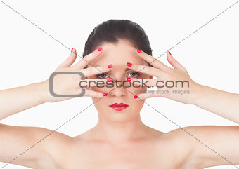 Woman with red lips and red painted finger nails over face