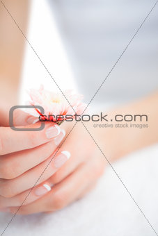 French manicured hands holding flower