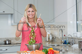 Portrait of woman preparing salad in the kitchen