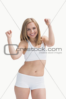 Portrait of an excited young woman in sportswear