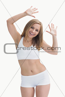 Portrait of an excited young woman in sportswear