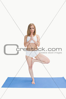 Young woman standing in praying position