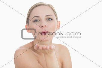 Closeup of cute young woman blowing a kiss