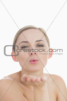 Closeup of cute young woman blowing a kiss