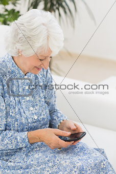 Elderly happy woman using a smartphone
