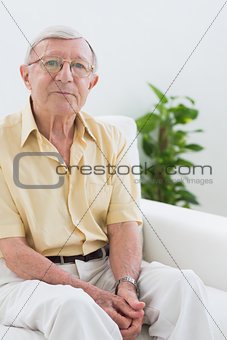 Elderly man sitting on the sofa