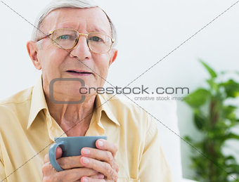 Elderly man with a cup