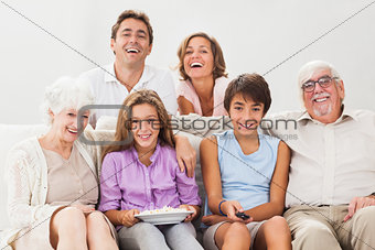 Multigeneration family on couch watching tv