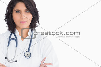 Pretty doctor with a stethoscope and arms crossed