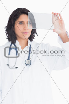 Doctor holding up virtual screen