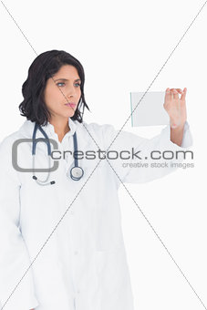 Female doctor looking at virtual clear screen