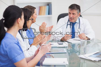 Nurses cheering a doctor