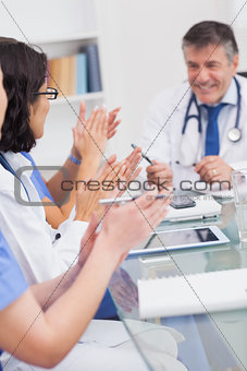 Nurses applauding a doctor