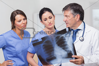 Doctor speaking about xray with nurses