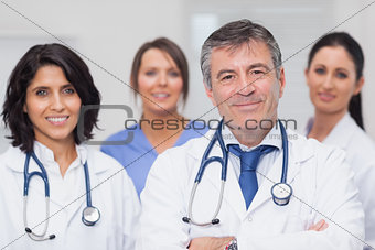 Two doctors and two nurses smiling