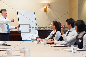 Businessman answering question during presentation