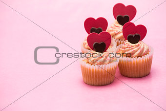 Four valentines cupcakes with heart decorations