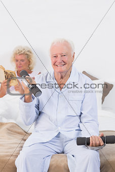 Old man lifting hand weights