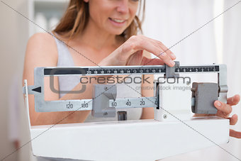 Woman adjusting scale