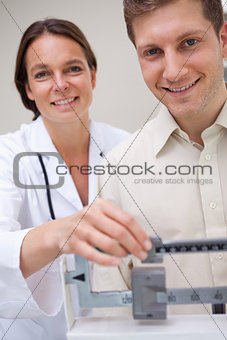 Doctor measuring patients weight