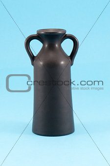 old ceramic vase with two handle blue background 