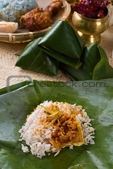 nasi lemak, a traditional malay curry paste rice dish served on 