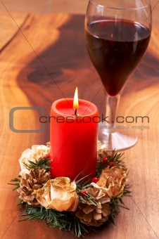 Christmas candle and a glass of wine
