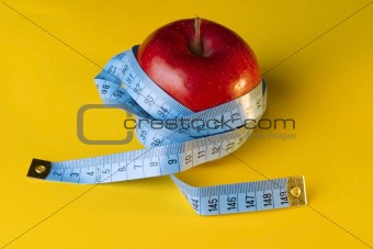 red apple and measuring tape