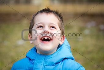 Portrait of a cute little boy playing outdoors