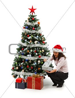 Opening Christmas presents near decorated tree