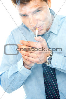 Young man lighting a cigarette