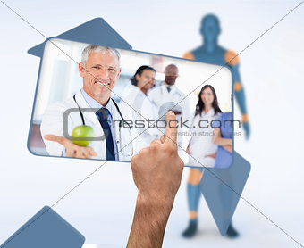 Hand selecting image of doctor holding apple in digital interface