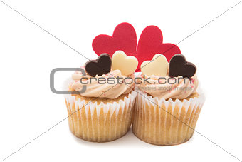 Two valentines cupcakes with heart decorations