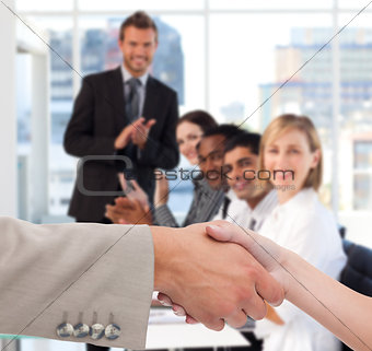 Businessman and woman shaking hands