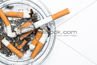 Overhead of burning cigarette in ashtray with copy space