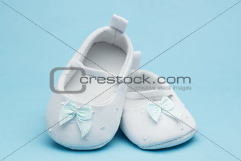 Baby booties with blue ribbon
