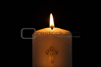 Candle with cross embellishment