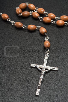 Rosary beads resting on a bible