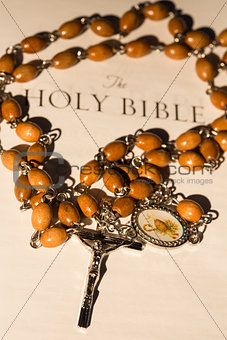 Rosary beads on page of bible