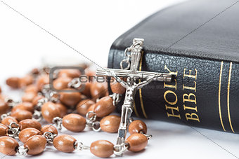 Black leather bound holy bible with rosary beads