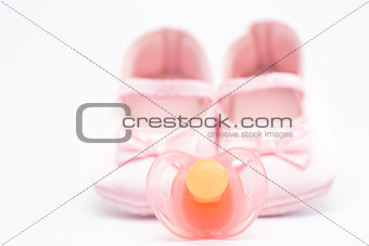 Pink baby booties with pink soother