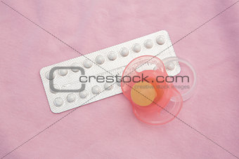 Contraceptive pill packet with pink soother
