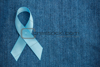 Blue ribbon for prostate cancer awareness on demin with copyspace