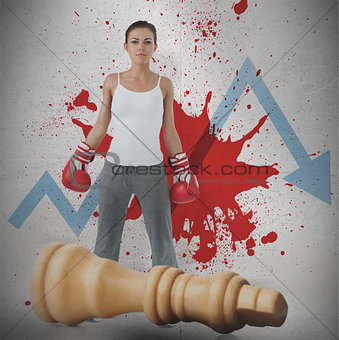 Female boxer against loss arrow and blood spatter with fallen chess piece