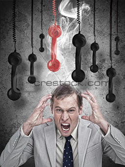Stressed out businessman with phone receivers