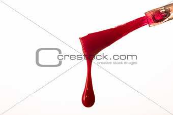 Red nail polish brush with drip